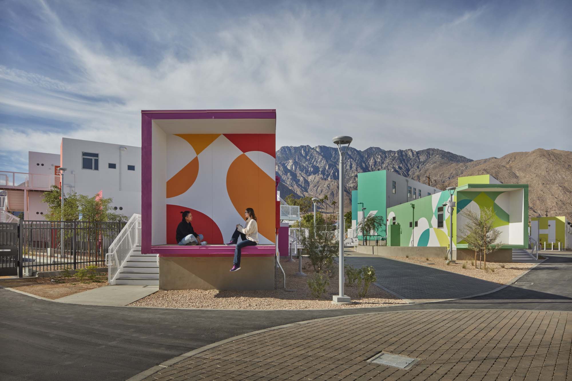 colorful housing units against mountain backdrop
