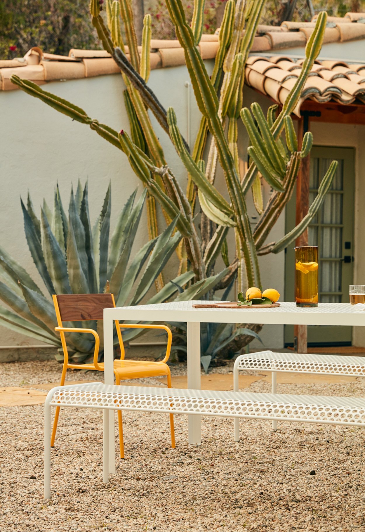 RAD Furniture outdoor white table with bench seating and yellow chair