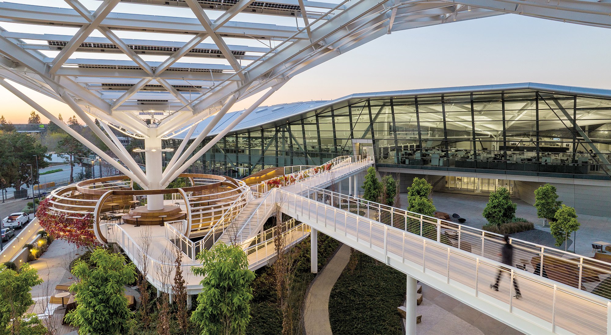 under the steel canopy of the Tree like structure inside the NVIDIA campus with multiple stairs attached to move across the open space.